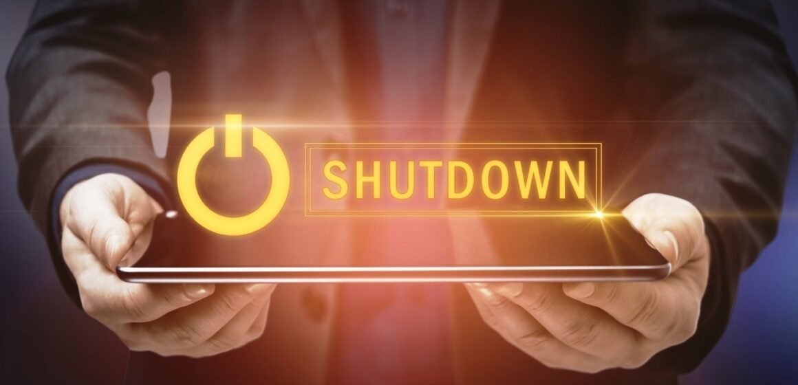 A graphical image of a man holding a tab with shutdown floating on the top, depicting US Healthcare AI program shutdown